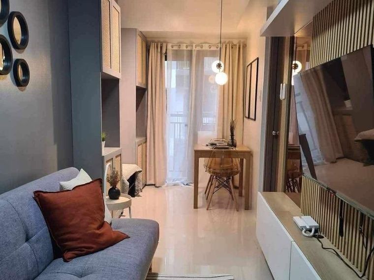 Compact living area with built-in cabinetry, a fitted media console and a dining table
