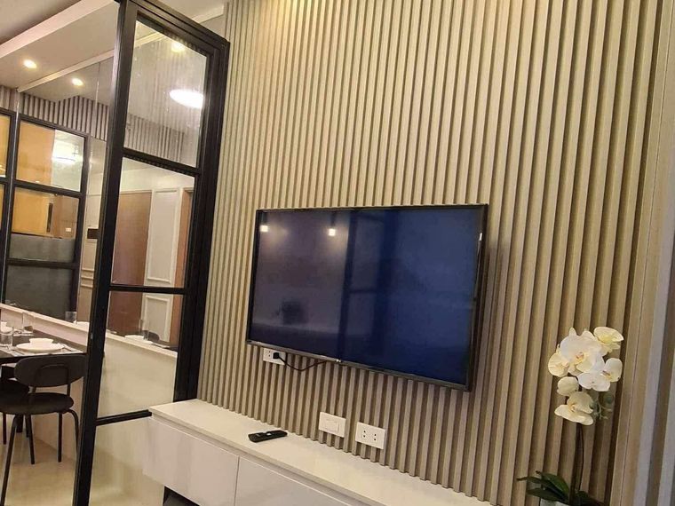 Fitted media wall and console built into a renovated living area