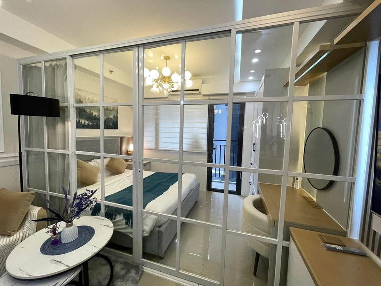Framed glazed partition installed between a bedroom and living area