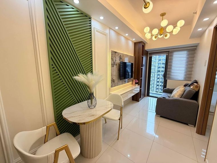 Living and dining area with a slatted feature wall and pendant lighting