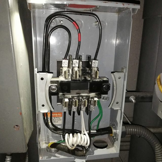 Main breaker and service conductors terminated inside an electrical enclosure